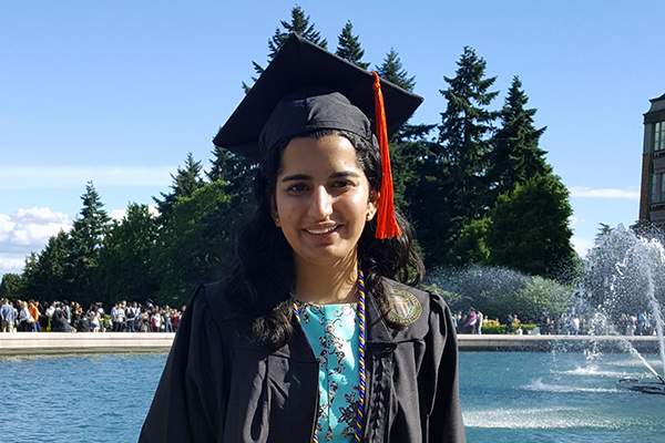 Pooja Sethi in cap and gown by Drumheller Fountain