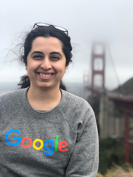 Woman in Google sweatshirt with foggy Golden Gate Bridge in background