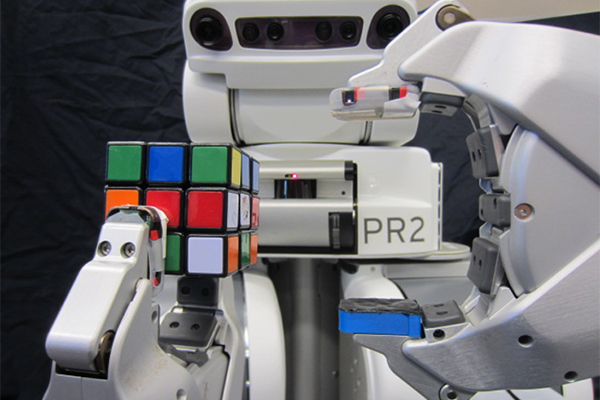 PR2 robot grasping Rubik's Cube in front of its face