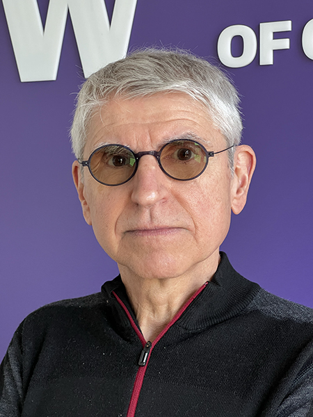Portrait of Dan Suciu in front of purple wall