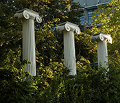 Four columns standing tall among the trees in Sylvan Grove.