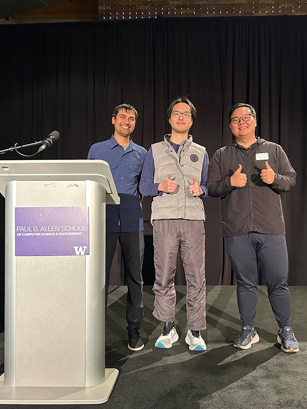 Winner of the People's Choice Award at the 2025 Research Showcase pose onstage after receiving their award.