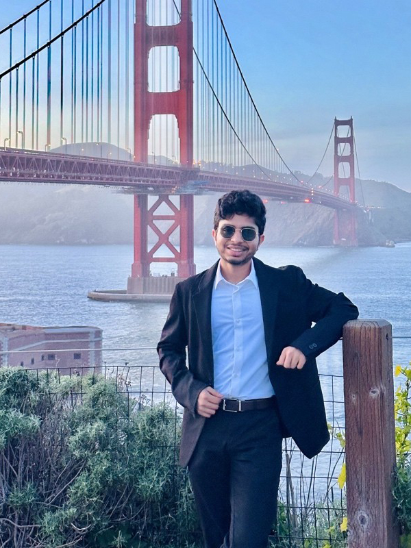 Sanket Guatum poses in front of the Golden Gate Bridge in San Francisco.