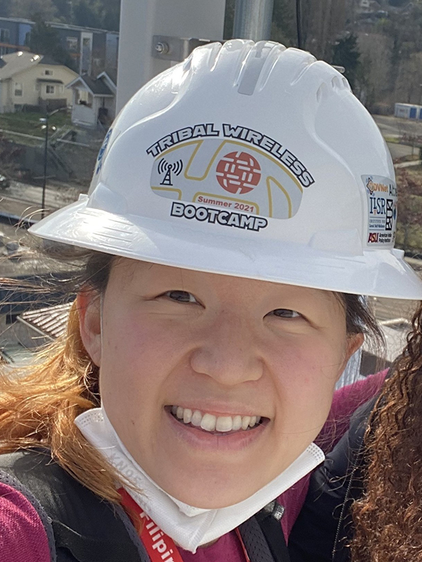 A photo of Allen School postdoc Esther Jang wearing a hard hat.