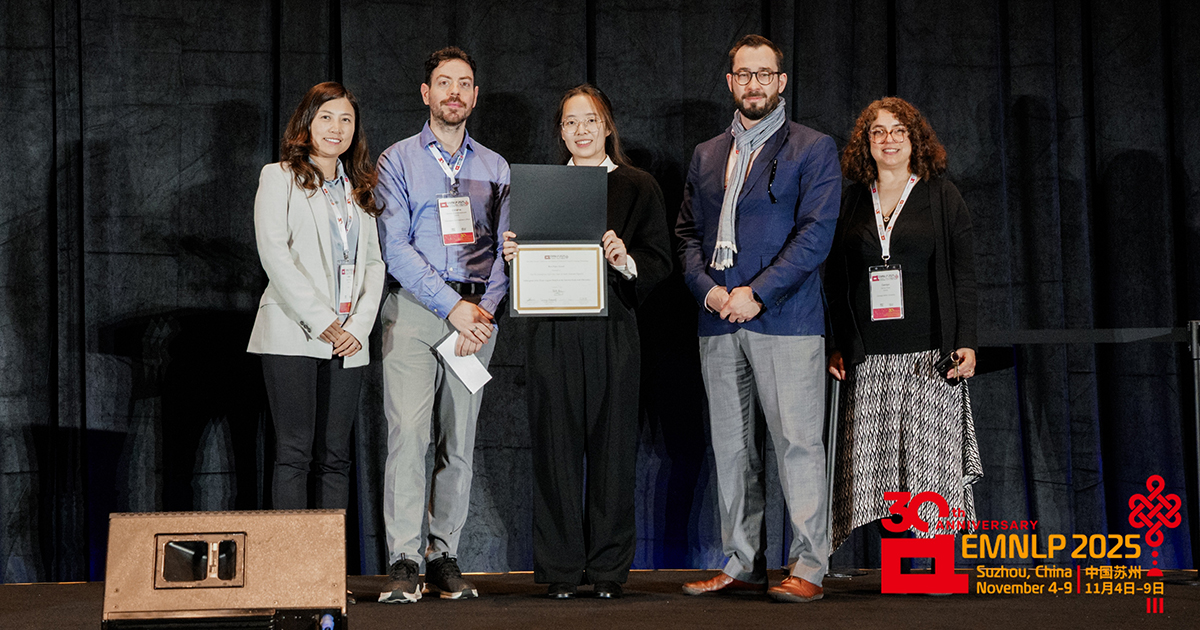 Hao Xu (center) accepts the EMNLP Best Paper Award among members of the conference program chairs.