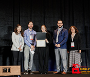 Hao Xu (center) accepts the EMNLP Best Paper Award among members of the conference program chairs.