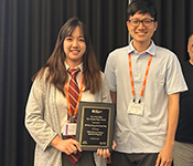 Mi-Ying (Miryam) Huang and Er-Cheng Tang hold the plaque they received for the Machtey Award for Best Student Paper.