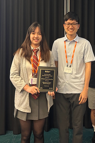 Mi-Ying (Miryam) Huang and Er-Cheng Tang hold the plaque they received for the Machtey Award for Best Student Paper.