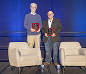 Allen School professor Richard Ladner holds the plaque he received for the SIGCSE Award for Outstanding Contribution to Computer Science Education. Next to him is Paul Tymann holding the plaque he received for the SIGCSE Award for Distinguished Service to the Computer Science Education Community.